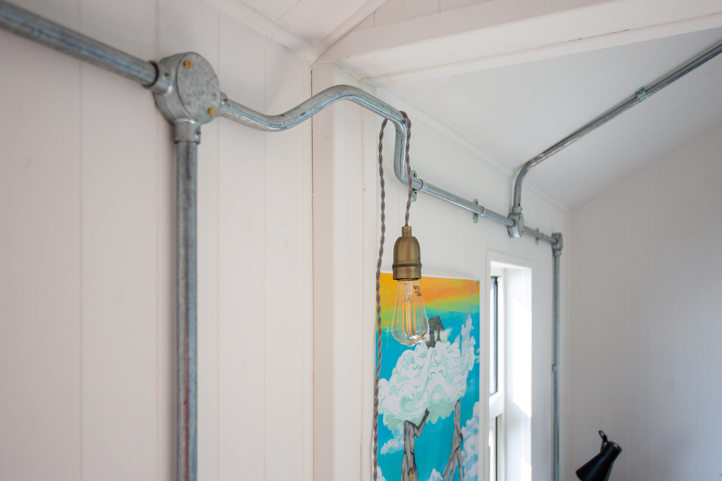 Decorative steel conduit throughout.