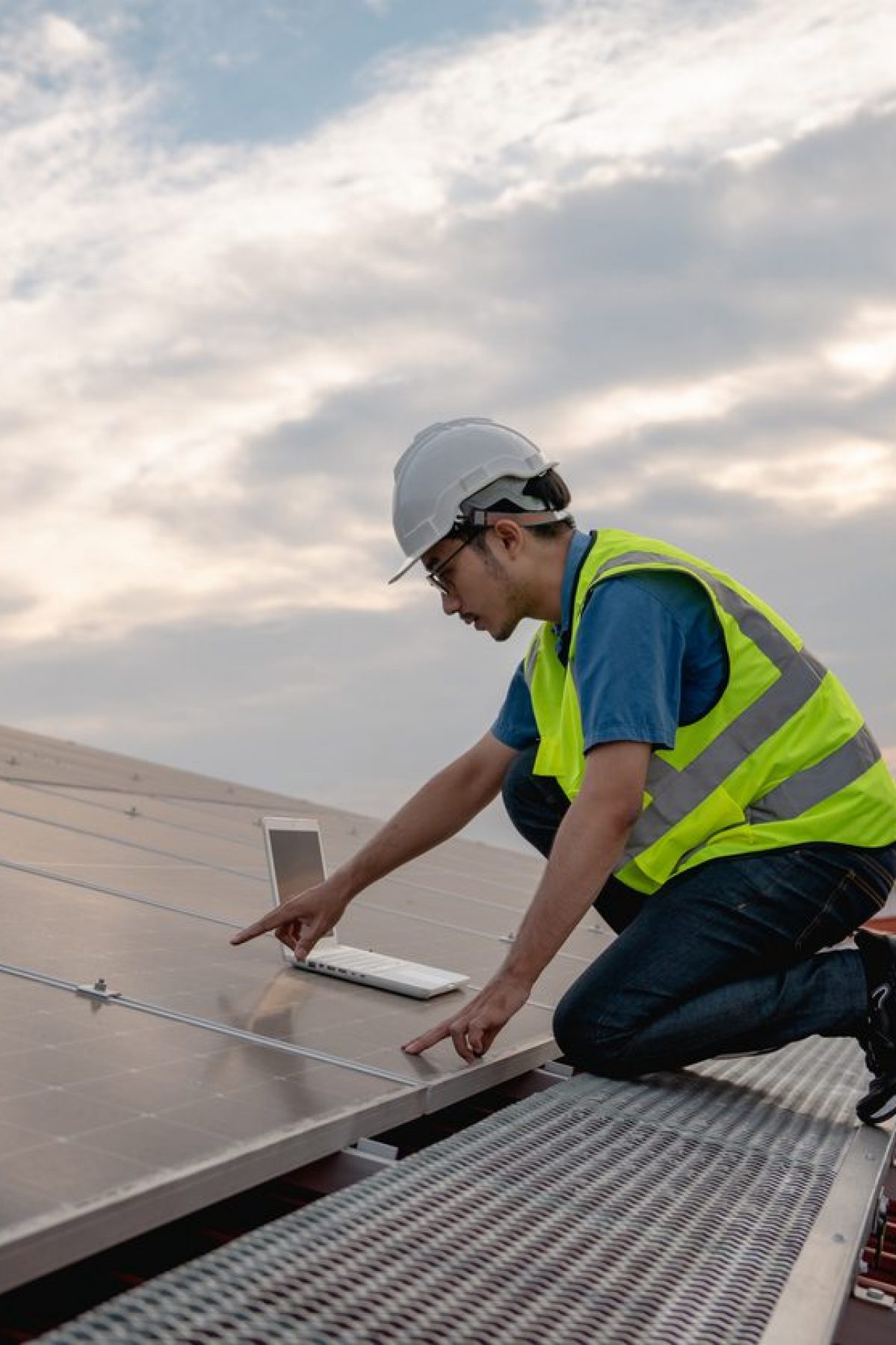 Service engineer checking solar cell on the roof for maintenance if there is a damaged part. Engineer worker install solar panel. Clean energy concept.